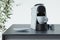Espresso coffee capsules machine in process of making fresh coffee in modern cozy kitchen. 3d rendering. Breakfast time.