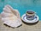 Espresso coffee in classic Italian ceramic cup served poolside on a sunny summer morning