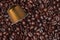 Espresso coffee golden capsule on coffee beans background