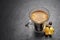 Espresso coffee mug with lemon peel on black background