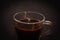 Espresso coffee in a small glass Cup close on a dark background