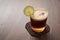 Espresso tonic in simple glass on walnut wood table with copy space