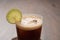 Espresso tonic in simple glass on walnut wood table with copy space