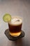 Espresso tonic in simple glass on walnut wood table with copy space