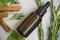 Essential oil bottle with rosemary herb and cinnamon sticks, herbal green botanical essential oil