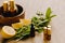 Essential oil in bottles with lemon and mint fragrance lying on a wooden surface