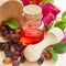 Essential oil in glass bottle, dried rose-hip berries in wooden