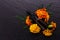 Essential oil marigold on a dark stone background