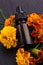Essential oil marigold on a dark stone background