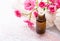 Essential oil, Mineral bath salts, branch of small pink rose on the wooden table