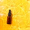 Essential oil in water on a yellow background. The concept of aromatherapy. The preservation of the health, natural cures.