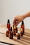 Essential oils bottles on wooden desk with candlelight beside