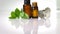 Essential oils in dark glass bottle with aroma herbs and Fresh leaves of basil and eucalyptus