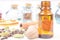 Essential oils in glass bottles maid from spices and nutmeg, cardamon, cinnamon, clove on the wooden background