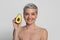 Essential Oils for Skincare And Beauty. Attractive middle-aged lady holding avocado half