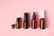 Essential oils , various bottles aromatherapy on a pink background