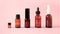 Essential oils , various bottles aromatherapy on a pink background