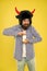 Essential vitamin you need. Bearded man open vitamin bottle. Hipster in hat with horns hold bottle of vitamin and