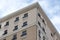 establish shot of a hotel building with balcony against blue sky