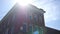 An establishing shot of a red brick old bank building in small American town on sunny afternoon