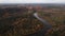 Establishing shot: Scenic autumn flight over Gauja river valley with Turaida castle in background