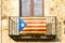 The Estelada starred flag hanging out of a building in Catalon