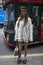Estelle Pigault wearing a white knit, Chloe bag, slippers, socks, flat cap during London Fashion Week September 2017 outside Eudon