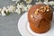 Ester cake with chocolate topping and nuts on gray background