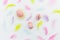 Ester composition with colorful eggs and pastel feathers on white background. Flat lay