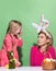 Ester for mother and daughter. Mom with little cute girl are preparing for Easter. Mother and daughter wearing bunny