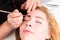 Esthetician Grooming Eyebrows of Female Client