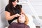 Esthetician Tidying Eyebrows of Female Client