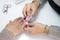 Esthetician using a buffing block to dehydrate nails