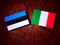 Estonian flag with Italian flag on a tree stump isolated