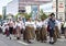 Estonian people in traditional clothing walking the streets of Tallinn