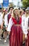 Estonian people in traditional clothing walking the streets of Tallinn