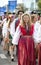 Estonian people in traditional clothing walking the streets of Tallinn