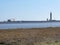 Estuary with boat at mooring and dock tower