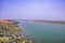 Estuary, mouth of a river, outlet with a boat at the east cost India at the Sunrise in a clear morning Spring time.