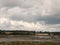 Estuary scene in manningtree with moored boats tide clouds lands