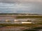 Estuary scene in manningtree with moored boats tide clouds lands
