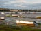 Estuary scene in manningtree with moored boats tide clouds lands