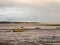 Estuary scene in manningtree with moored boats tide clouds lands