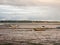 Estuary scene in manningtree with moored boats tide clouds lands