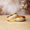 Eternal Sparkle: Close-Up of Wedding Rings and Glitter with Bokeh Background