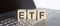 ETF abbreviation stands for written on a wooden cube on laptop