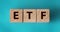 ETF, Exchange Traded Fund, realtime mutual index fund that can trade in equity stock market, cube wooden block with alphabet