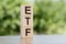 ETF, Exchange Traded Fund, realtime mutual index fund that can trade in equity stock market, cube wooden block with alphabet