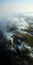 Ethereal Aerial View: Billowing Smoke Over Water