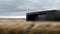 Ethereal Danish Design: A Black Building Amidst Coastal Views